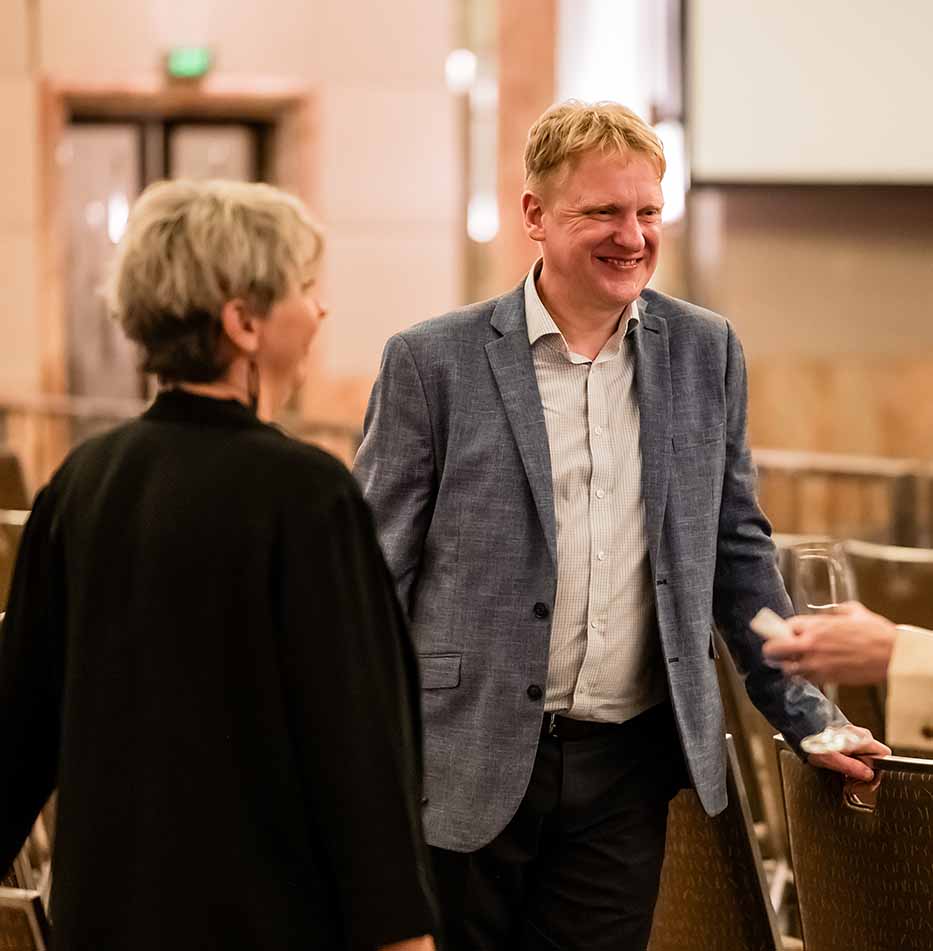 Work With Us - Staff talking at graduation